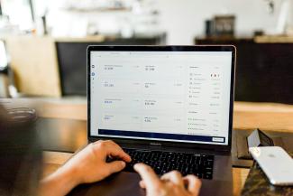 person using MacBook pro by Austin Distel courtesy of Unsplash.